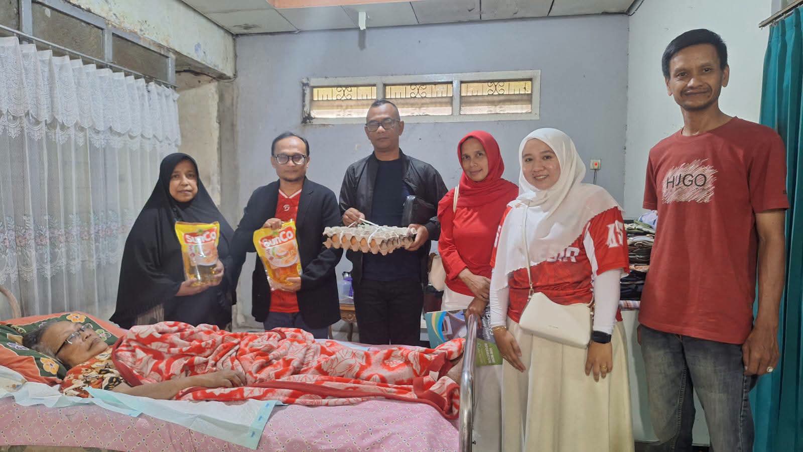 Kadinsos Winarno didampingi Lurah Johan saat serahkan bantuan ke salah seorang warga.